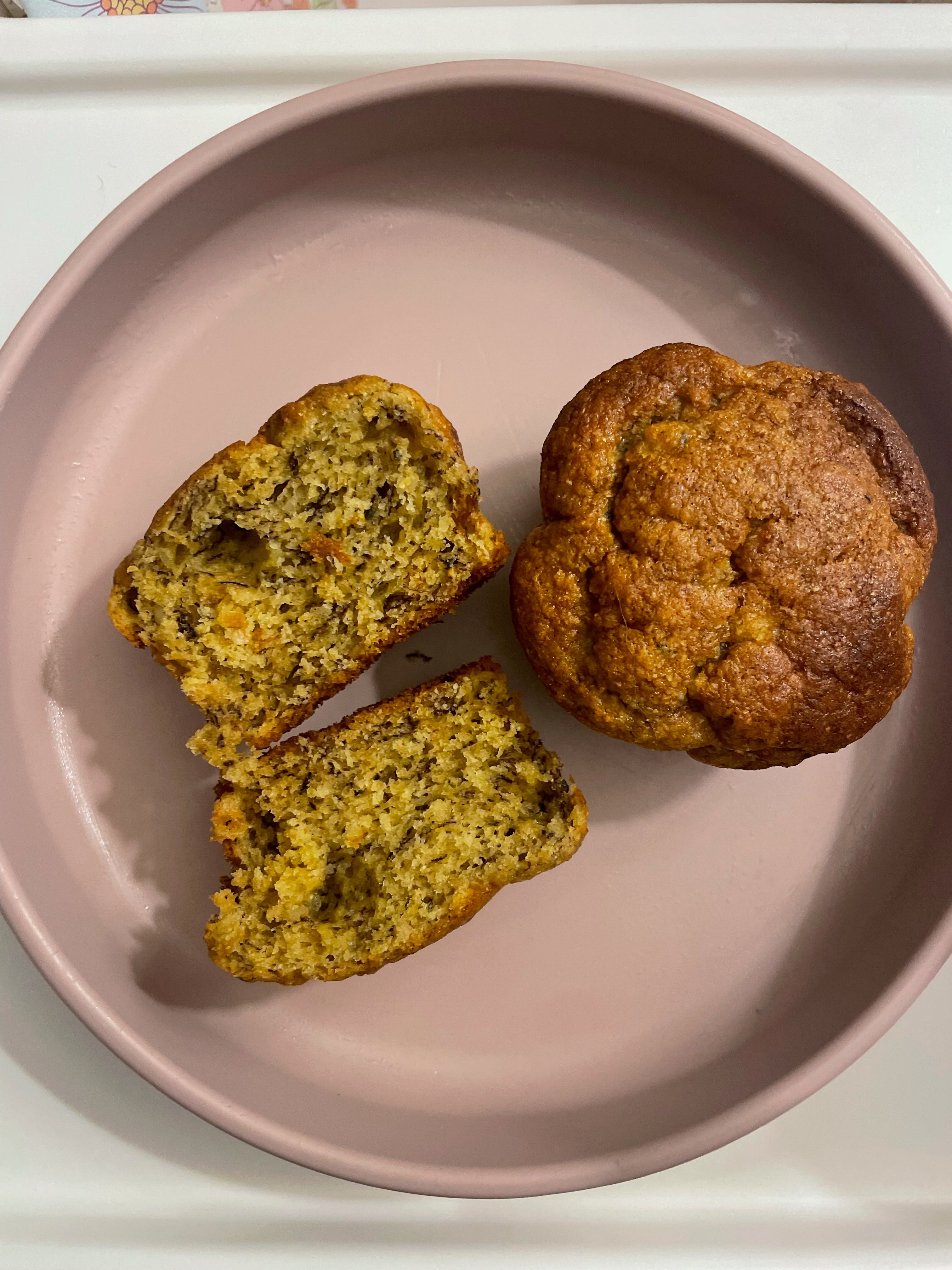 Fresh muffin sliced on pink plate, ideal for mess-free mealtime with easy cleanup